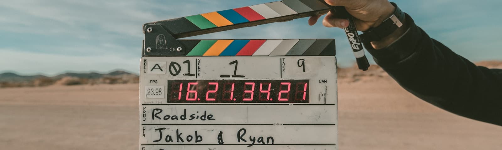 Film production crew on an active set with camera and lighting equipment