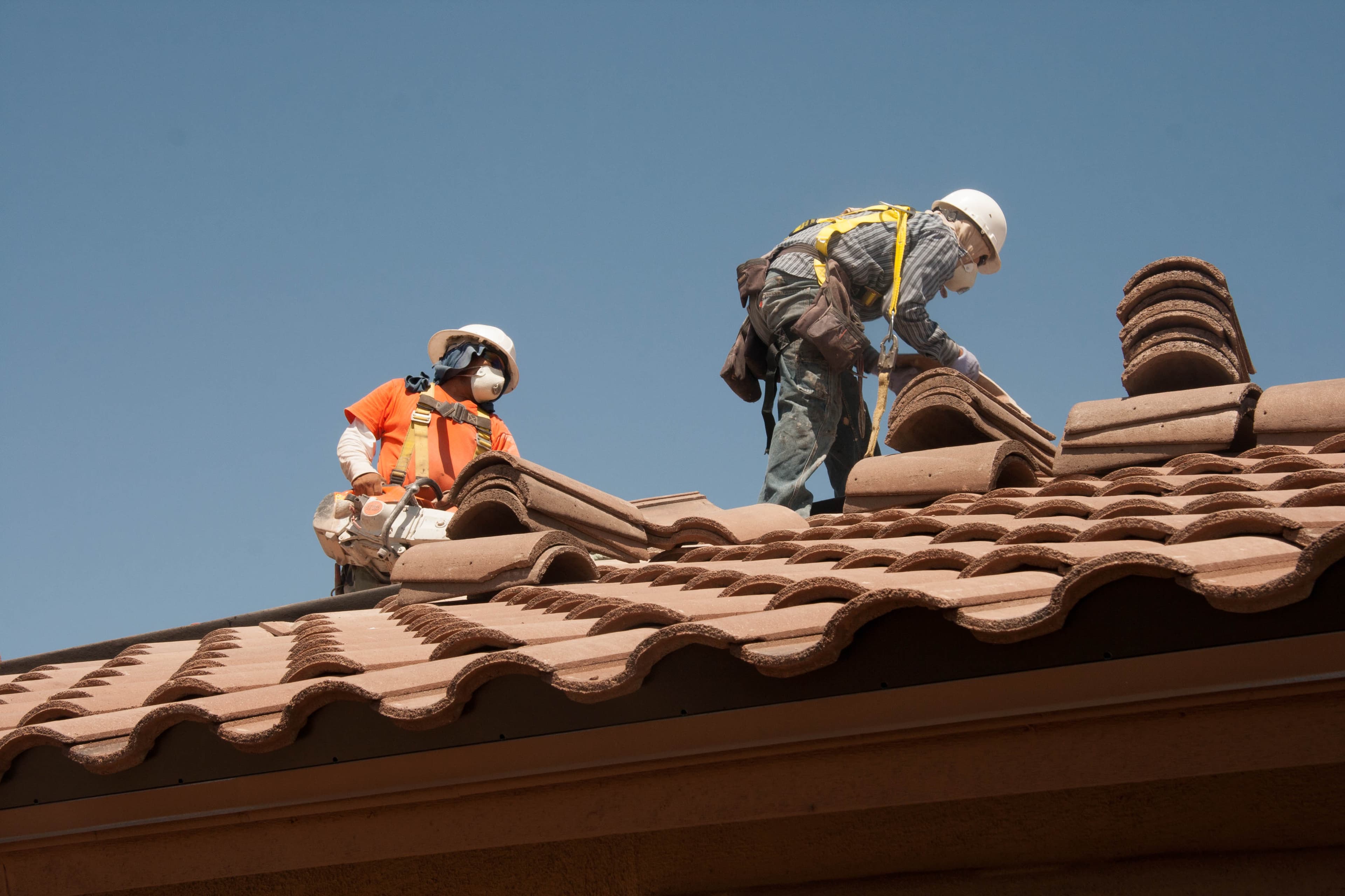 Crew working on a commercial roof during an energy-related installation